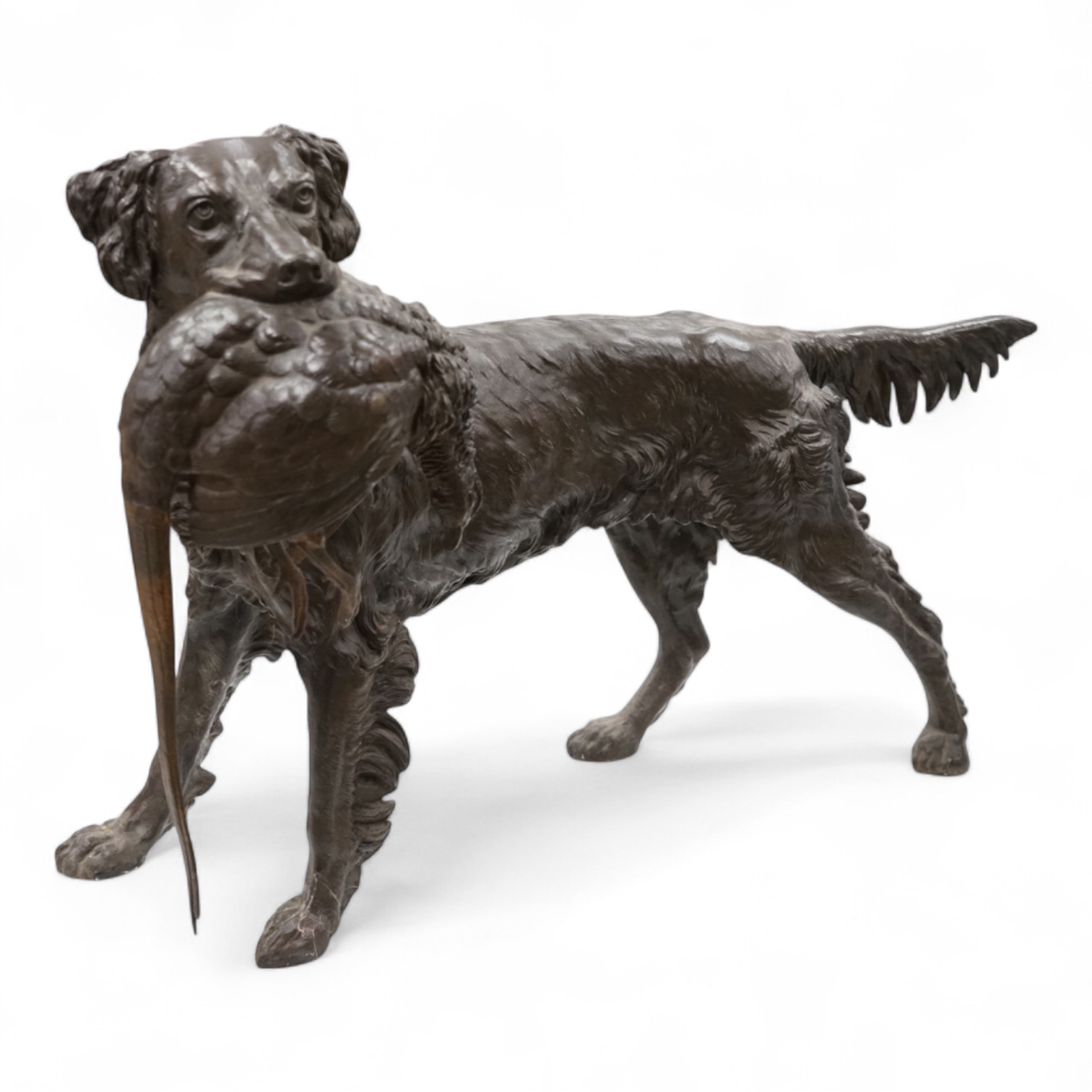 A large bronzed metal study of a retriever and pheasant, 56cm wide